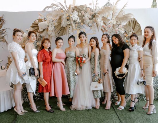 Photo by Trung Nguyen: https://www.pexels.com/photo/happy-bride-with-friends-on-wedding-celebration-5096322/