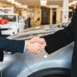 Photo by Antoni Shkraba: https://www.pexels.com/photo/close-up-of-men-shaking-hands-and-cars-in-background-7144199/